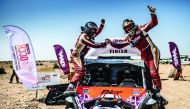 Qaar’s Adel Abdulla and French co-driver Jean-Michel Polato celebrate victory in the Dubai International Baja in this March 2019 file picture.