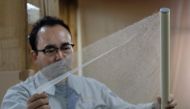 This picture taken on March 15, 2019 shows Hidaka Washi president Hiroyoshi Chinzei, a fourth-generation traditional paper maker, displaying the world's thinnest paper at his factory in Hidaka, Kochi prefecture, some 640 kilometres (400 miles) southwest o