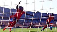 Uganda's defender Hassan Wasswa (L) celebrates a goal of his team during the 2019 Africa Cup of Nations (CAN) football match between DR Congo and Uganda at Cairo International Stadium on June 22, 2019. / AFP / JAVIER SORIANO