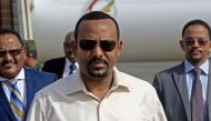 (FILES) In this file photo taken on June 07, 2019 Ethiopia's Prime Minister Abiy Ahmed (C) arrives at Khartoum international airport on June 7, 2019. AFP / ASHRAF SHAZLY