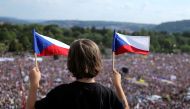 A demonstrator waves flags of the Czech Republic as he attends a protest rally demanding the resignation of Czech Prime Minister Andrej Babis in Prague, Czech Republic, June 23, 2019. Reuters/Milan Kammermayer