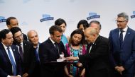 French President Emmanuel Macron (C-L) listens to his French Foreign Affairs Minister Jean-Yves Le Drian duirng the Mediterranean Summit (The Sommet des Deux Rives/Summit of the Two Shores ) which is being held in the city of Marseille, southern France, o