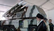 Iran's Supreme Leader Ayatollah Ali Khamenei is seen near a 