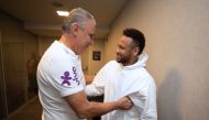 Brazilian player Neymar (R) is greeted by Brazil team coach Tite as he visits his teammates at the hotel where the team is staying during the 2019 Copa America in Sao Paulo, Brazil on June 21, 2019. / AFP / Brazilian Football Confederation (CBF) / Lucas F
