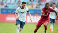 File photo of the players of Argentina (L) and Qatar during their Copa America Group B match in Porto Alegre, Brazil, on Sunday. 