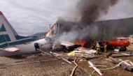 An Antonov An-24 passenger plane is seen on fire after an emergency landing in the town of Nizhneangarsk, Russia June 27, 2019. Russian Emergencies Ministry/Handout via REUTERS 