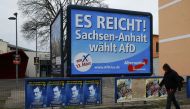 A man walks past an election poster of the right-wing Alternative for Germany AfD party, reading 'Thats enough, Germany' on March 13, 2016. Reuters/Wolfgang Rattay 