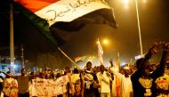 FILE PHOTO: Sudanese people, seeking to revive a push for civilian rule in ongoing tumult since the overthrow of former President Omar al-Bashir more than two months ago, chant slogans and wave Sudanese flags during a demonstration in Khartoum, Sudan, Jun