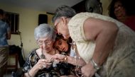 Cuban Delia Barroso, 102, receives a present during her birthday in Havana, on May 18, 2019. AFP / ADALBERTO ROQUE