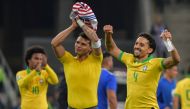 Brazil's Willian (L), Thiago Silva (C) and Marquinhos acknowledge the crowd after defeating Paraguay in a penalty shoot-out during their Copa America football tournament quarter-final match at the Gremio Arena in Porto Alegre, Brazil, on June 27, 2019. (A