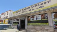 A Libyan man walks past a Turkish restaurant in Tripoli on June 30 , 2019. (AFP / Mahmud TURKIA)