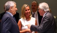 President of the European Commission Jean-Claude Juncker (R) speaks with President of European Parliament Antonio Tajani (L) and European Union High Representative for Foreign Affairs and Security Policy Federica Mogherini (C) during extraordinary summit 