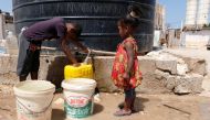 Libyan children displaced from the town of Tawergha fill containers with water at a displaced camp in Benghazi, Libya, June 19, 2019. Picture taken June 19, 2019. REUTERS/Esam Omran Al-Fetori