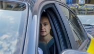 German captain of humanitarian ship Sea-Watch 3, Carola Rackete (Rear in car) looks on as she leaves in a car of the Italian Guardia di Finanza law enforcement agency on July 1, 2019 after appearing before a judge at the courthouse in Agrigento, Sicily. A