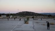 Pakistani men living in Greece play a game of tape-ball cricket in a disused parking lot for trucks in an industrial area in Elefsina, Greece, June 30, 2019. REUTERS/Alkis Konstantinidis