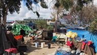 A homeless encampment made of tents and tarps lines the Santa Ana riverbed near Angel Stadium in Anaheim, California, January 25, 2018. AFP/Robyn Beck