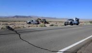 A crack on Highway 178 is seen as construction workers fix a broken water line south of Trona, after a 6.4-magnitude earthquake hit in Ridgecrest, California, on July 4, 2019. (AFP / FREDERIC J. BROWN)