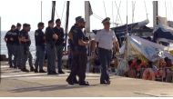 A still image from a video footage shows police officers guarding a migrant rescue boat, which docked at the port of Lampedusa in defiance of a ban on entering Italian waters, in Lampedusa, Italy, July 6, 2019. (Local Team/REUTERS TV via REUTERS) 