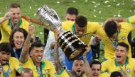 Brazil players celebrate winning the Copa America with the trophy. Reuters/Sergio Moraes