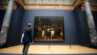 In this file photo taken on April 4, 2013, a visitor admires Rembrandt's masterpiece 