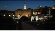 The Campidoglio (Rear C) and the Roman Forum are pictured as the moon rises over Rome within the outdoors presentation of Italian fashion house Fendi's Couture Fall/Winter 2019-2020 show on July 4, 2019, at the Palatine Hill in Rome, with the Colosseo (Co