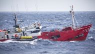 Members of Greenpeace film a Spanish fishing vessel capturing sharks near the Portuguese Azores, Portugal, June 26, 2019. (Greenpeace Handout via Reuters)
