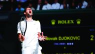 Serbia's Novak Djokovic reacts after a point against Spain's Roberto Bautista Agut during their men's singles semi-final match on day 11 of the 2019 Wimbledon Championships at The All England Lawn Tennis Club in Wimbledon, southwest London, on July 12, 20