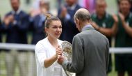Romania's Simona Halep is presented the trophy by Britain's Prince Edward, the Duke of Kent, after winning the final against Serena Williams of the US. (REUTERS/Carl Recine)
