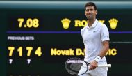 Serbia's Novak Djokovic celebrates beating Switzerland's Roger Federer during their men's singles final on day thirteen of the 2019 Wimbledon Championships at The All England Lawn Tennis Club in Wimbledon, southwest London, on July 14, 2019. AFP / Ben Sta