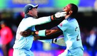England's Jos Buttler (L) and England's Jofra Archer celebrates after they win the super over to win the 2019 Cricket World Cup final between England and New Zealand at Lord's Cricket Ground in London on July 14, 2019.  AFP / Paul Ellis 