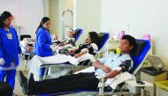Employees and guests donating blood.
