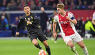 Juventus' Portuguese forward Cristiano Ronaldo (L) and Ajax's Dutch defender Matthijs de Ligt run with the ball during the UEFA Champions League first leg quarter-final football match between Ajax Amsterdam and Juventus FC at the Johan Cruijff Arena in Am