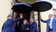 Assistants hold umbrellas to shield Russia's President Vladimir Putin (L) and his Belarusian counterpart Alexander Lukashenko from rain during a meeting in Saint Petersburg, Russia July 18, 2019. Sputnik/Mikhail Klimentyev/Kremlin