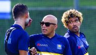 Sri Lankan coach Chandika Hathurusingha (centre) talks with Dasun Shanaka (left) as Lasith Malinga looks on during a training session in Dubai, in this September 14, 2018 file photo.