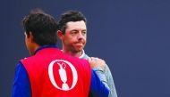 Northern Ireland's Rory McIlroy looks dejected with his caddie after not making the cut.  Reuters/Paul Childs