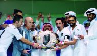 Al Sadd’s Spanish skipper Xavi Hernandez, coach Jesualdo Ferreira, players and officials hold the Falcon Shield after winning the 2018/19 QNB Stars League (QSL) title at the Al Sadd Stadium in this April 4 file photo.
