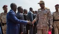 Sudan deputy Head of Military Council Mohamed Hamdan Dagalo (2nd-R) is welcomed at Juba international airport upon his arrival from Khartoum on July 27, 2019 in South Sudan. (AFP / AKUOT CHOL)