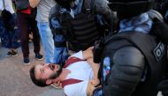 Law enforcement officers detain a participant of a rally calling for opposition candidates to be registered for elections to Moscow City Duma, the capital's regional parliament, in Moscow, Russia July 27, 2019. REUTERS/Tatyana Makeyeva