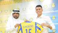 Mexican international Hector Moreno holding his Al Gharafa jersey with a club official during a press conference yesterday. 