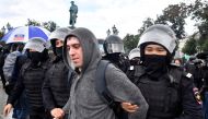 Riot police officers detain a participant of an unsanctioned rally urging fair elections at Moscow's Pushkinskaya Square on August 3, 2019. AFP / Alexander NEMENOV
