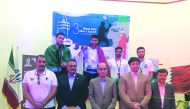 Men’s singles gold medallist, Qatar’s Abdullah Al Tamimi (top, centre) and his team-mate, joint-bronze winner Syed Azlan Amjad, celebrate on the podium with officials during the West Asian Squash Championship in Tehran, Iran, yesterday.
