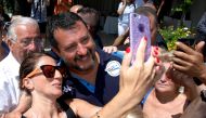 Italian Interior Minister and leader of the League party Matteo Salvini poses for a selfie as he meets supporters at the Caparena beach in the Sicilian seaside town of Taormina, Italy, August 11, 2019. (REUTERS/Antonio Parrinello)