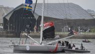 Swedish climate activist Greta Thunberg (C) climbs aboard the Malizia II IMOCA class sailing yacht from an RIB off the coast of Plymouth, southwest England, on August 14, 2019, as she prepares to start her journey across the Atlantic to New York where she