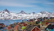 Snow covered mountains rise above the harbour and town of Tasiilaq, Greenland, June 15, 2018. (REUTERS/Lucas Jackson/File Photo)