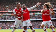 Arsenal's Pierre-Emerick Aubameyang celebrates scoring their second goal with teammates Alexandre Lacazette and Matteo Guendouzi. (REUTERS/David Klein)