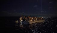 FILE PHOTO: Migrants onboard an inflatible boat wait for being rescued off the coast of Libya by Proactiva Open Arms organisation.  AFP / Olmo CALVO