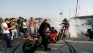 A biker wheelspins on his motorbike during a car and motorbike show outside the closed Hall of Shaab Stadium in Baghdad, Iraq August 16, 2019. Picture taken August 16, 2019 REUTERS/Thaier Al-Sudani