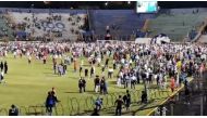 Football fans walk in a football field in Tegucigalpa, Honduras August 17, 2019 in this still image obtained August 18, 2019 from a social media video. 