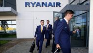 (FILES) In this file photo taken on September 21, 2017 Staff leave Ryanair headquarters at Airside Business Park in Dublin on September 21, 2017. AFP / Paul Faith 