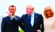French President Emmanuel Macron (L) and his wife Brigitte welcome Britain's Prime Minister Boris Johnson (C) at the Biarritz lighthouse, southwestern France, ahead of a working dinner on August 24, 2019. AFP / Pool / Francois Mori

